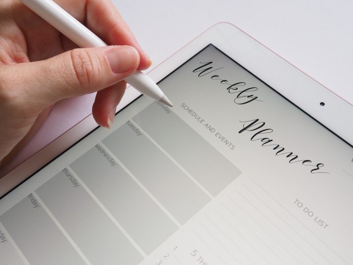 iPad 2018 with Apple Pencil 1st generation and person writing on planner